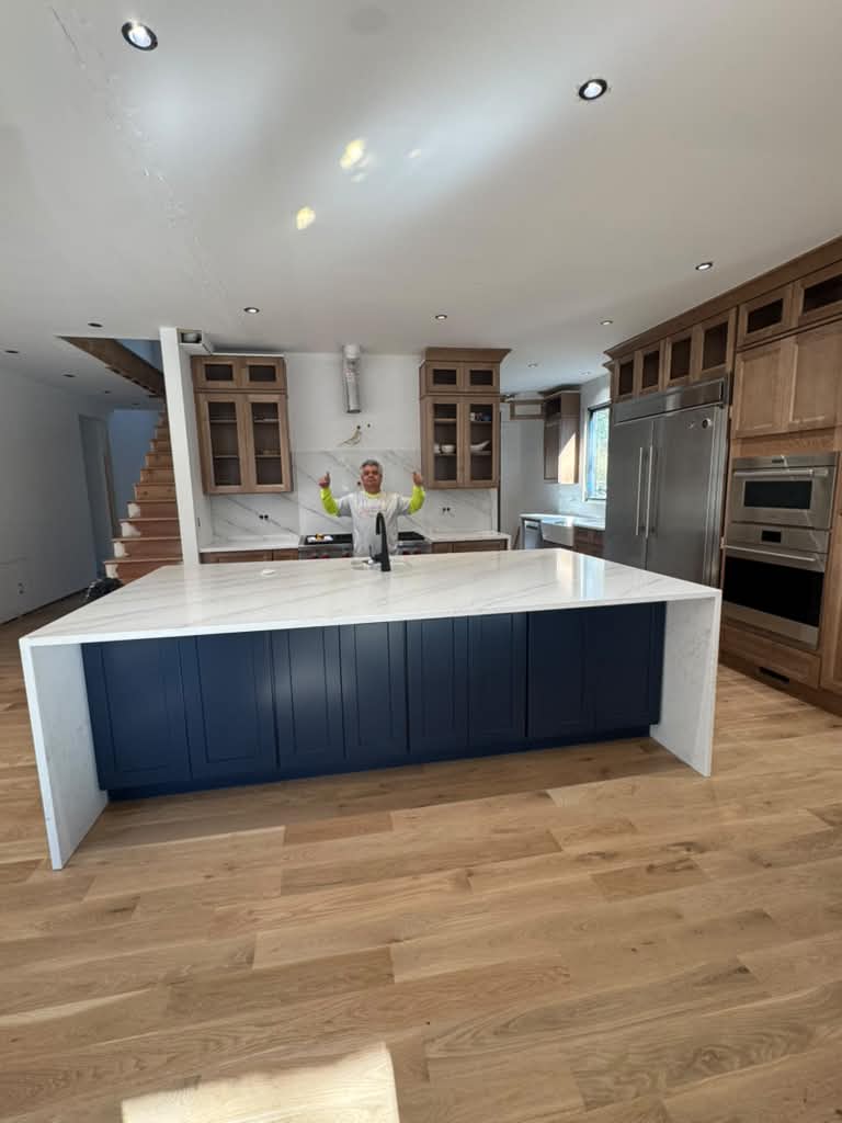 Navy waterfall island with custom cabinetry