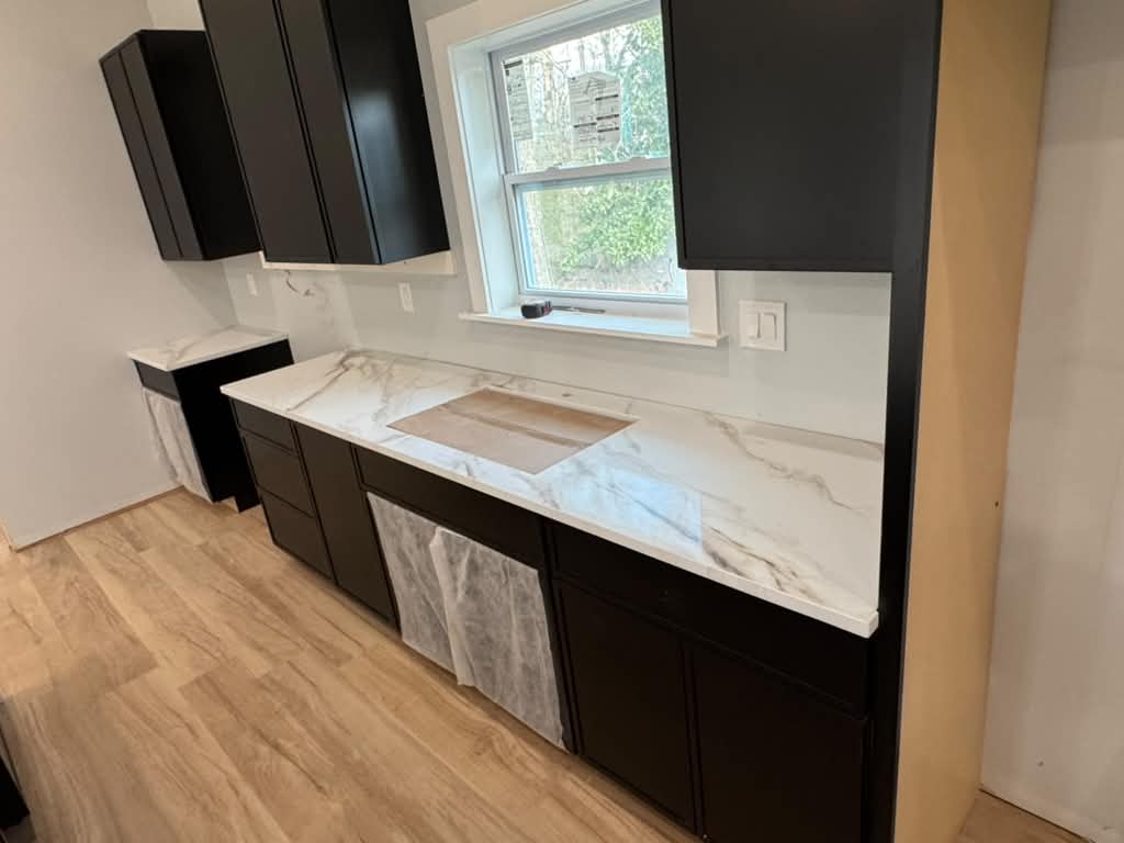 Black shaker cabinets with marble-look countertop